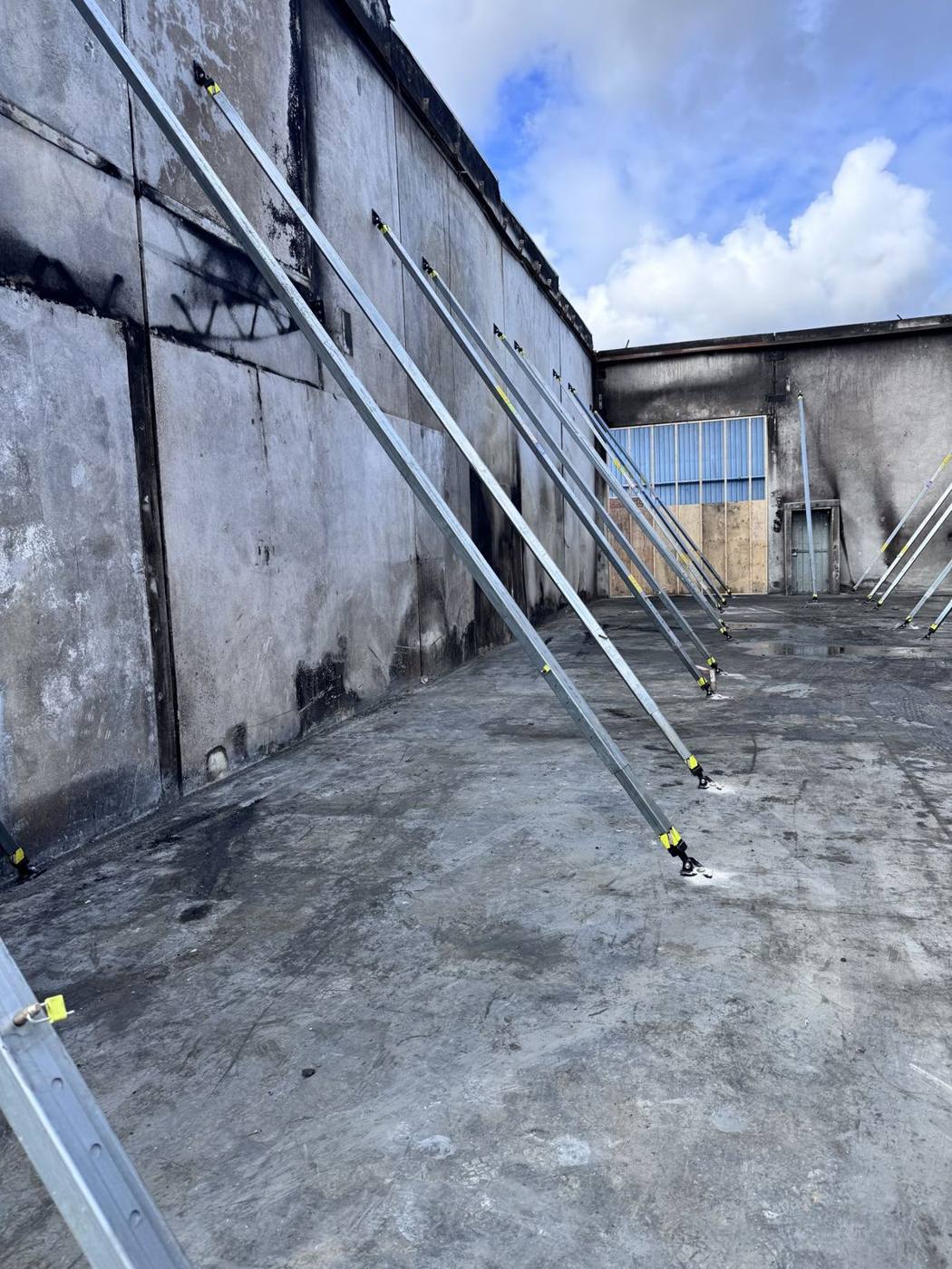 Fire-damaged building with tilt panels supported by raking props