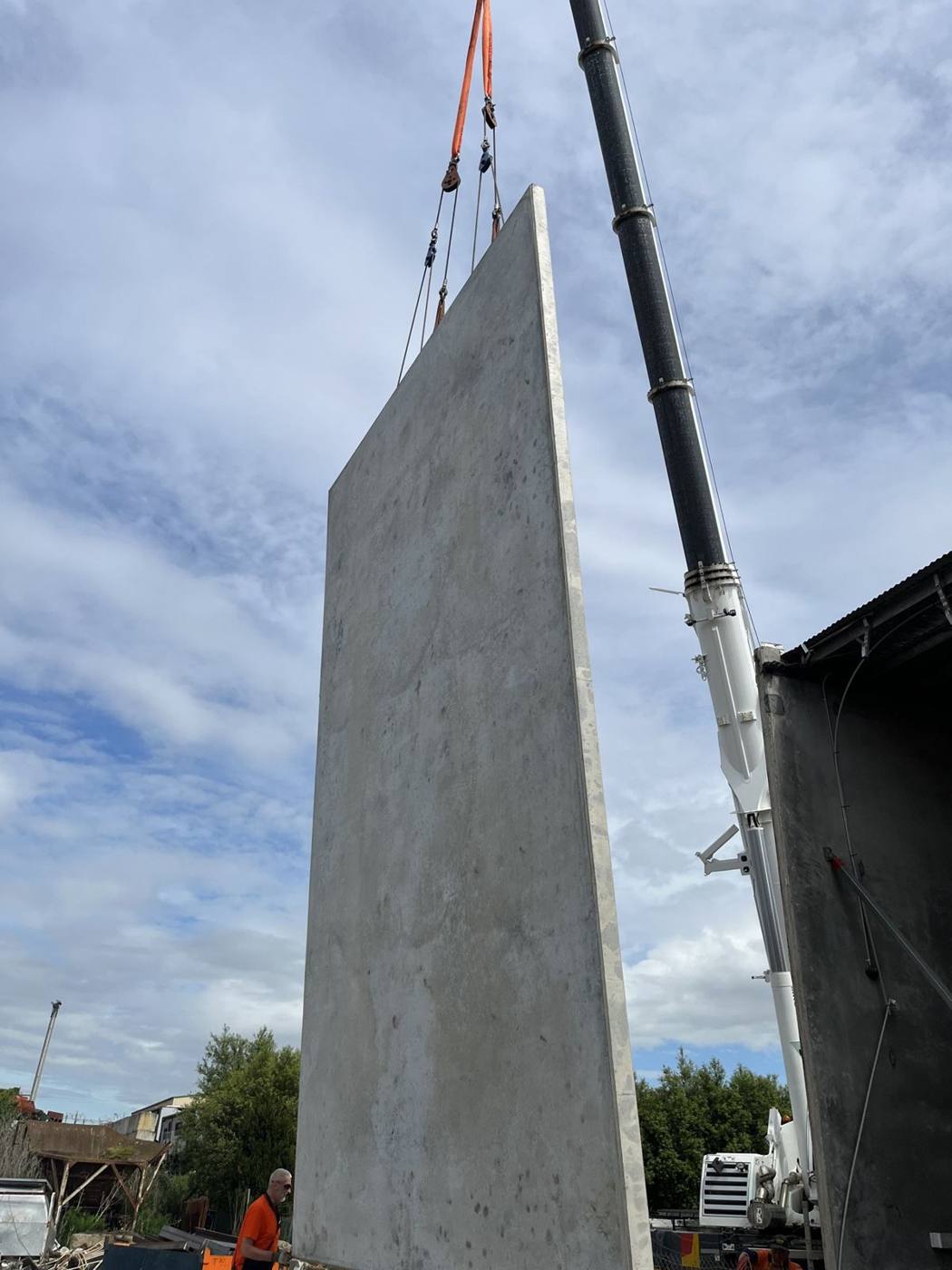 New precast panel suspended from a crane ready to be stood