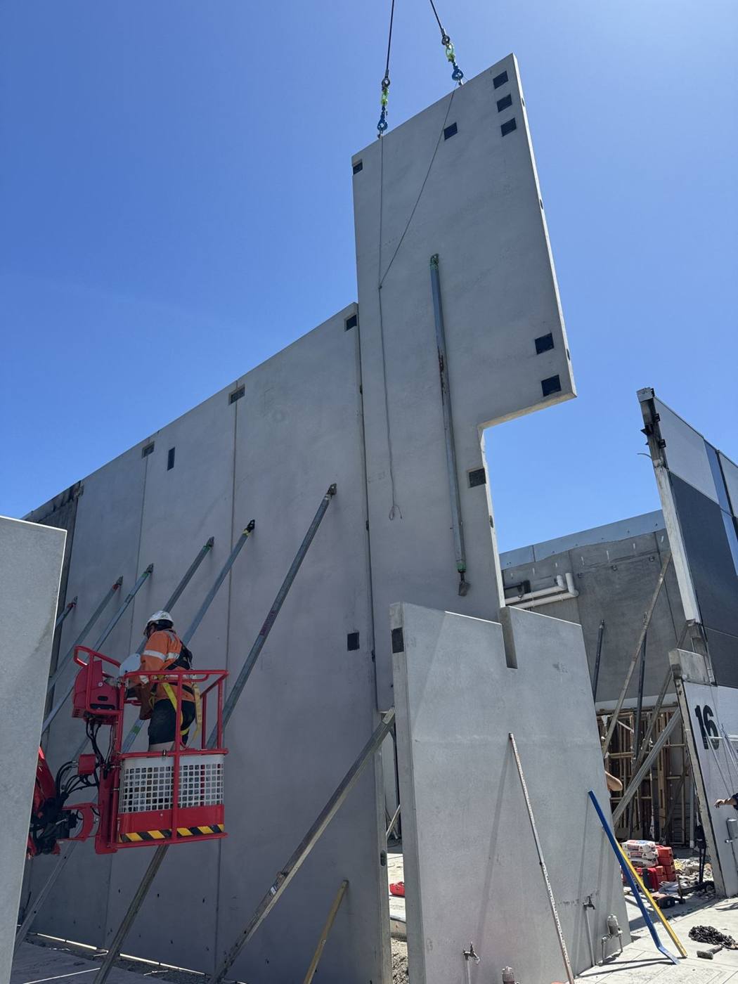 Tall tilt panels standing with an elevated work platform alongside