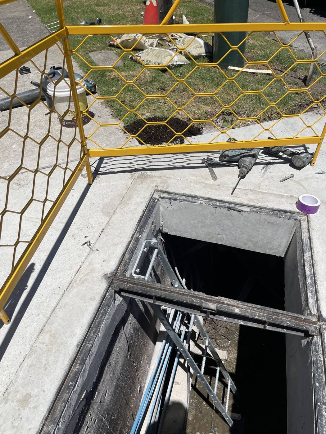 New telecommunications pit installed with safety barriers around it