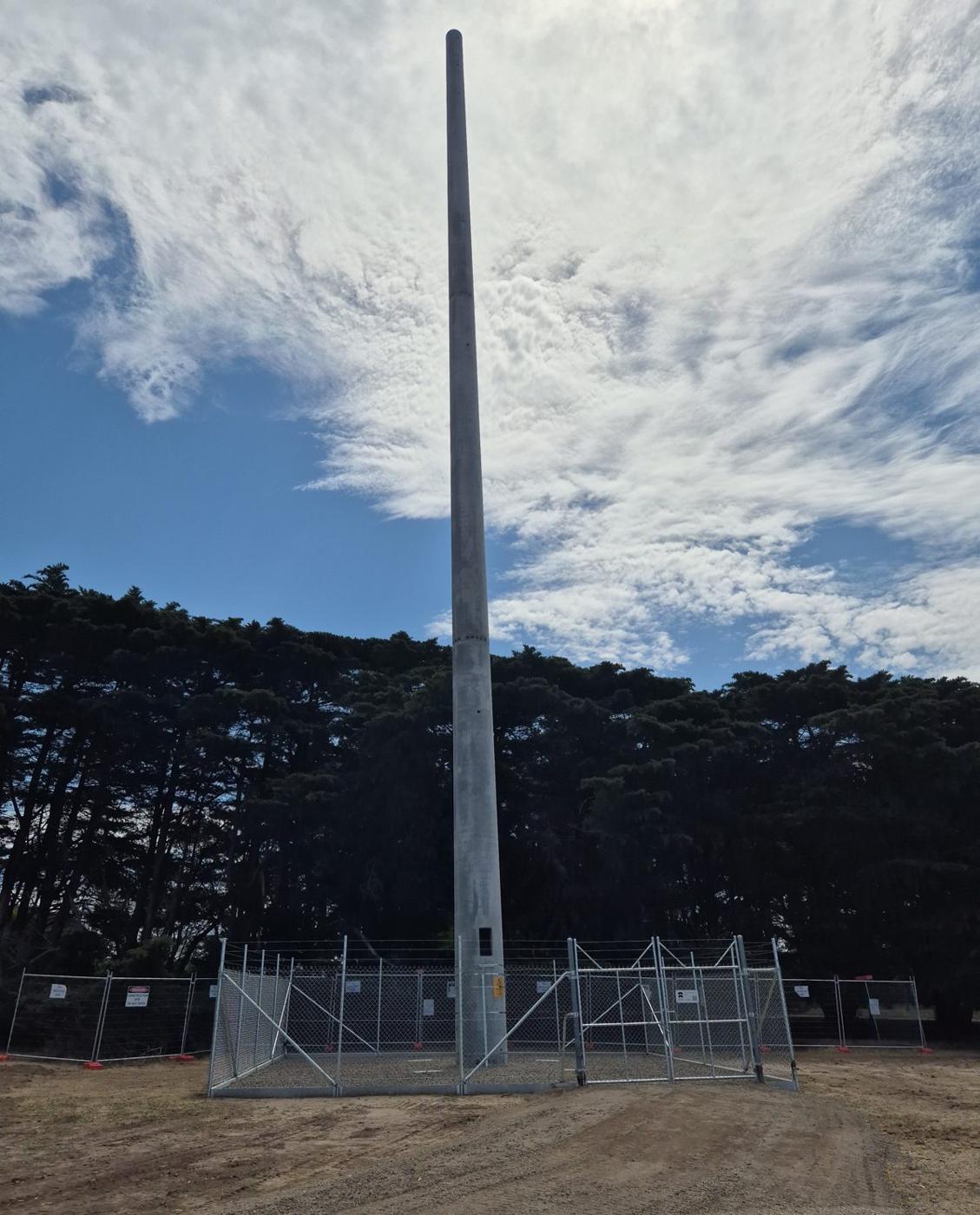 Completed monopole tower inside a fenced compound