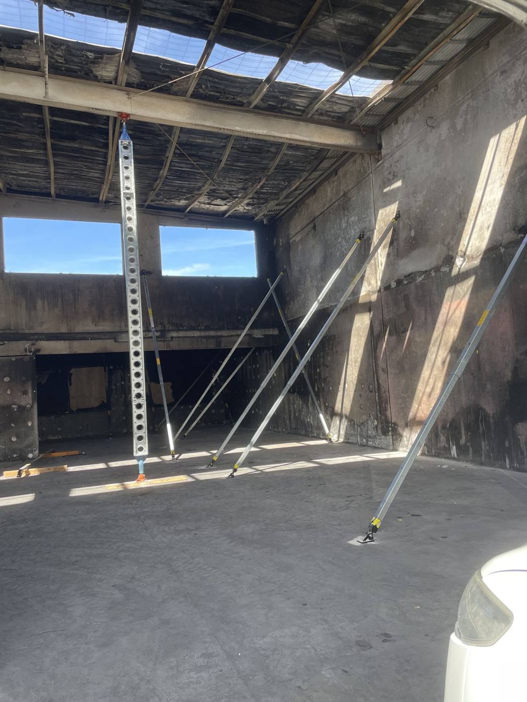 Fire-damaged warehouse with props installed to support the structure